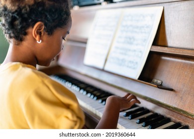Musical Education. Happy Black Girl Playing The Piano