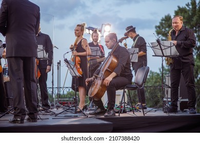 Musical ensemble having concert rehearsal on the street - Shutterstock ID 2107388420
