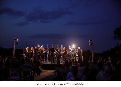 Musical ensemble performing live concert at night