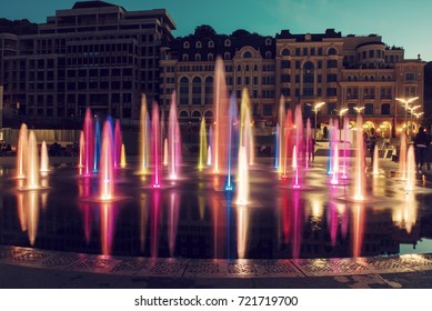 Musical fountain with colorful illumination at night with reflection. Ukraine, Kiev. Travel entartainment sightseeing background