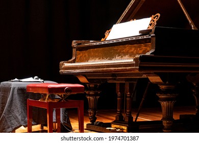 Musical Instrument. Beautiful Piano On Stage With Overhead Spot Lighting.