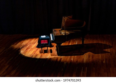 Musical Instrument. Beautiful Piano On Stage With Overhead Spot Lighting.