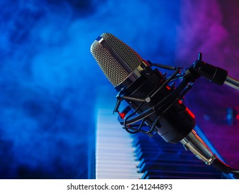 Musical Instrument - Midi Keyboard And Microphone For Singing On A Blue Smoky Background. Concert, Nightclub, Video Clip Recording. Color Image. There Are No People In The Photo. Advertising. Banner.