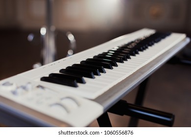 A Musical Instrument Stands, A White Keyboard Synthesizer