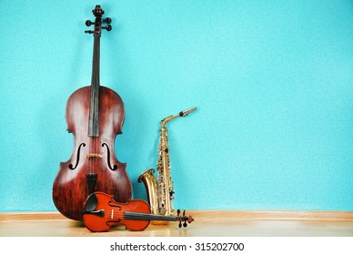 Musical instruments on turquoise wallpaper background
