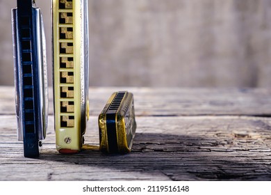 Musical instruments vintage harmonics diatonic and chromatic on old wooden desk. world music day. Horizontal orientation. - Shutterstock ID 2119516148
