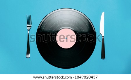 musical record on a blue background flat lay