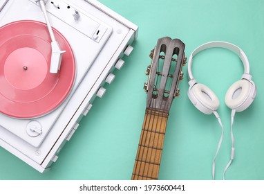 Musical, sound equipment on a blue background. Vinyl record player, guitar and stereo headphones on a mint blue background. Top view. Flat lay - Powered by Shutterstock