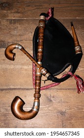 Musical traditional instrument bagpipes on wooden background.