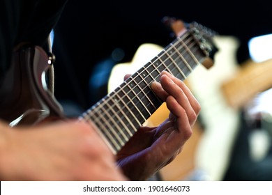 Musician fingers on electric guitar strings close up - Powered by Shutterstock