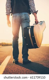 The Musician Goes With The Guitar In The Case.