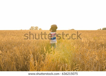 Similar – Image, Stock Photo Hand holding an acoustic guitar with black background with a dramatic and cinematic tone in chiaroscuro