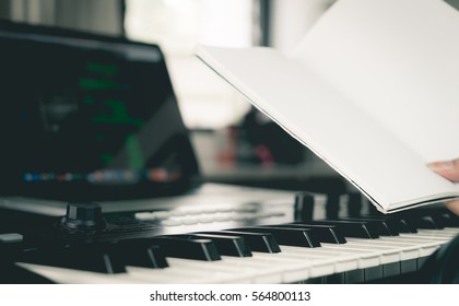 Musician Is Holding A Blank Book For Song Writing