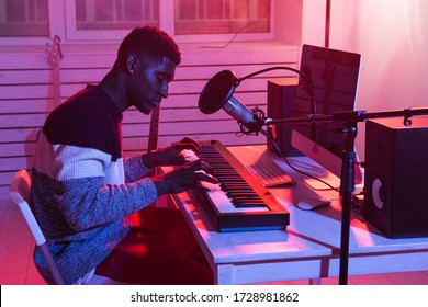 Musician and making music concept - African american male sound producer working in recording studio. - Powered by Shutterstock