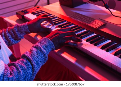 Musician and making music concept - African american male sound producer working in recording studio, close-up. - Powered by Shutterstock