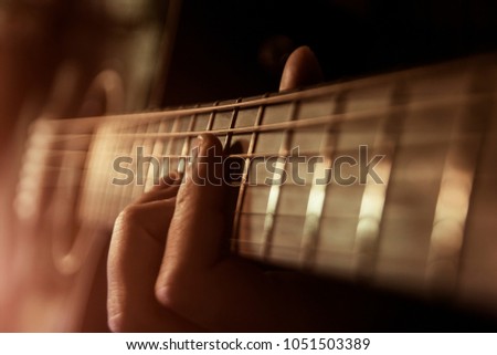 Musician man is playing the guitar