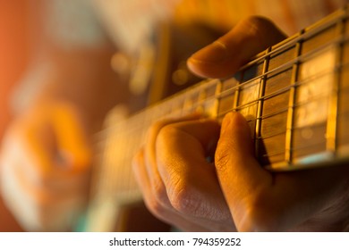 Musician Man Is Playing The Guitar On The Concert