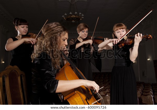 Musician play violin on\
dark background