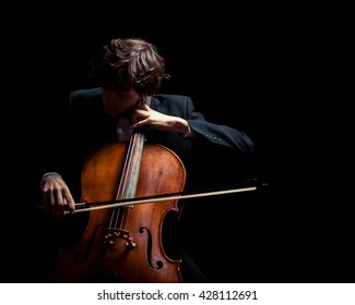 Musician Playing The Cello. Black Background