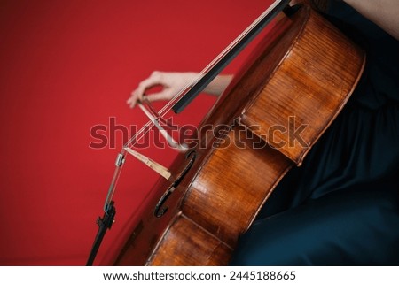 Musician playing cello. Cellist or Cello player performing with monochrome  background, beautiful filmic, artistic  beautiful woman playing the cello