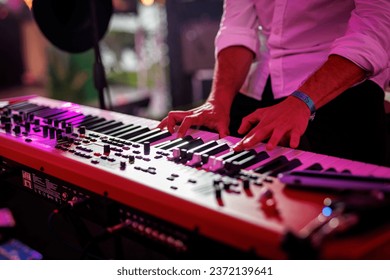 Musician playing electronic musical keyboard synthesizer