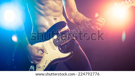 Musician playing the guitar on the stage