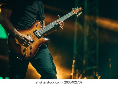 Musician playing guitar while performing on a concert on a festival - Powered by Shutterstock