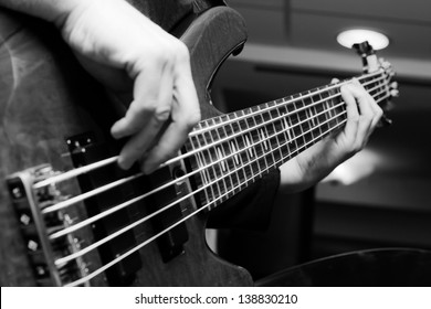 Musician Playing On Bass Guitars.