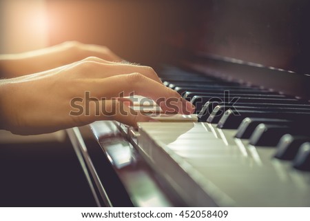 Musician playing piano in church with vintage filter.