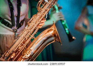 Musician playing saxophone on blurred background, melody music sound.
