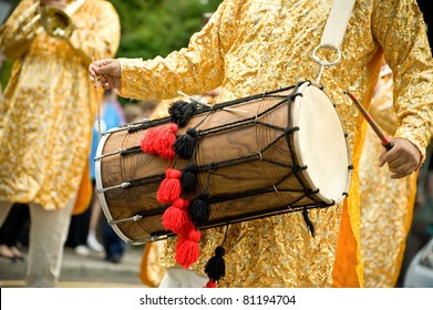 Musician Playing A Traditional Asian Dhol Drum