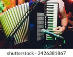 The musician plays the accordion close-up microphone