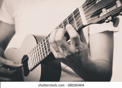 Musician plays Acoustic Guitar, B&W old film processed Vintage Photo Style