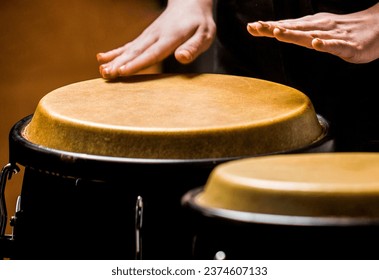 Musician plays the bongo. Close up of musician hand playing bongos drums. Afro Cuba, rum, drummer, fingers, hand, hit. Drum. Hands of a musician playing on bongs. - Powered by Shutterstock