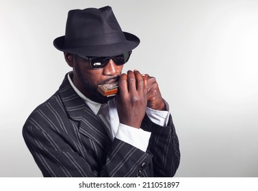 musician plays the harmonica on white background