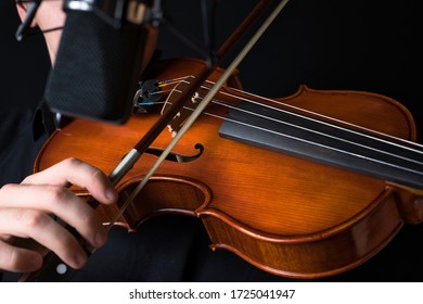 Musician Plays Viola in a Recording Studio with a Microphone
