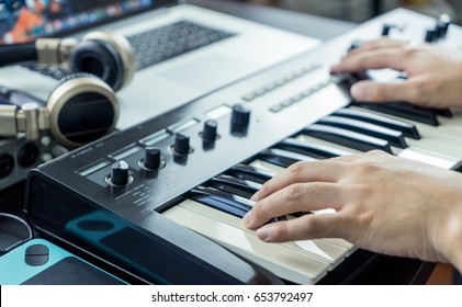 Musician Is Recording Keyboard On To Computer Music Studio