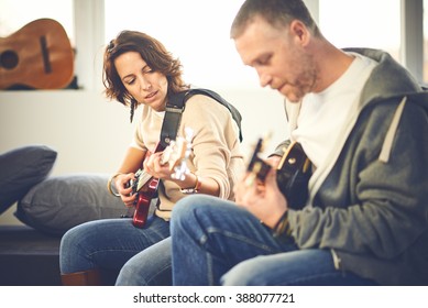 Musician teaching his girlfriend playing electric guitar - Powered by Shutterstock