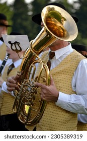 Musicians in costume plays baritone, a form of Tenor Horns