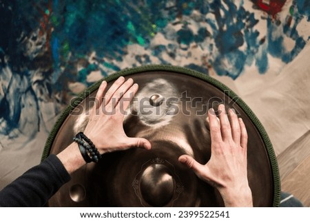 the hand of a woman touches the naked bottom of a statue