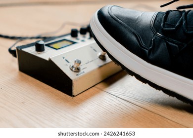 musician's male foot pressing bass drum pedal or bass electric guitar recording studio close-up - Powered by Shutterstock