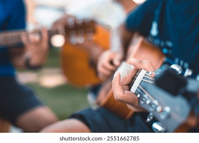 Musicians strumming acoustic guitars in an outdoor setting, focusing on hands and strings, evoking creativity and harmony. - Powered by Shutterstock