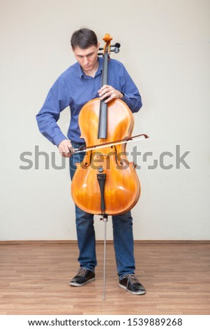 Musicians of the symphony orchestra. Cellist at a rehearsal. Portrait.