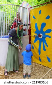 MUSKOGEE, OK - MAY 24: A Man Dressed As A Woman Calls People For A Game Of Dunk Tank At The Oklahoma 19th Annual Renaissance Festival On May 24, 2014 At The Castle Of Muskogee In Muskogee, OK 