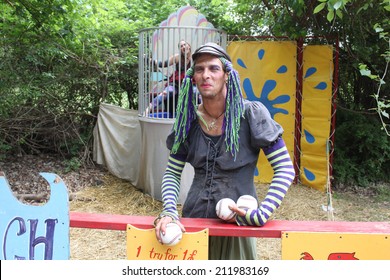 MUSKOGEE, OK - MAY 24: A Man Dressed As A Woman Calls People For A Game Of Dunk Tank At The Oklahoma 19th Annual Renaissance Festival On May 24, 2014 At The Castle Of Muskogee In Muskogee, OK 