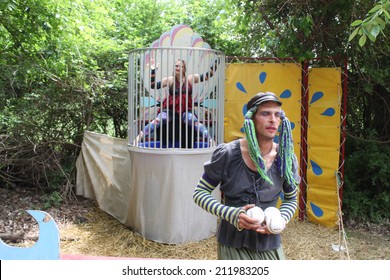 MUSKOGEE, OK - MAY 24: A Man Dressed As A Woman Calls People For A Game Of Dunk Tank At The Oklahoma 19th Annual Renaissance Festival On May 24, 2014 At The Castle Of Muskogee In Muskogee, OK 