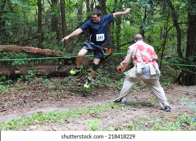 MUSKOGEE, OK - Sept. 13: Athletes Try To Avoid Bloody Zombies During The Castle Zombie Run At The Castle Of Muskogee In Muskogee, OK On September 13, 2014. 