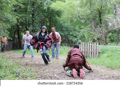 MUSKOGEE, OK - Sept. 13: Athletes Try To Avoid Bloody Zombies During The Castle Zombie Run At The Castle Of Muskogee In Muskogee, OK On September 13, 2014. 