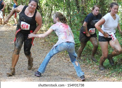 MUSKOGEE, OK - Sept. 14: Athletes Try To Avoid Bloody Zombies During The Castle Zombie Run At The Castle Of Muskogee In Muskogee, OK On September 14, 2013.