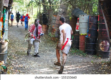 MUSKOGEE, OK - Sept. 14: Athletes Run Through Mud And Avoid Zombies During The Castle Zombie Run At The Castle Of Muskogee In Muskogee, OK On September 14, 2013.